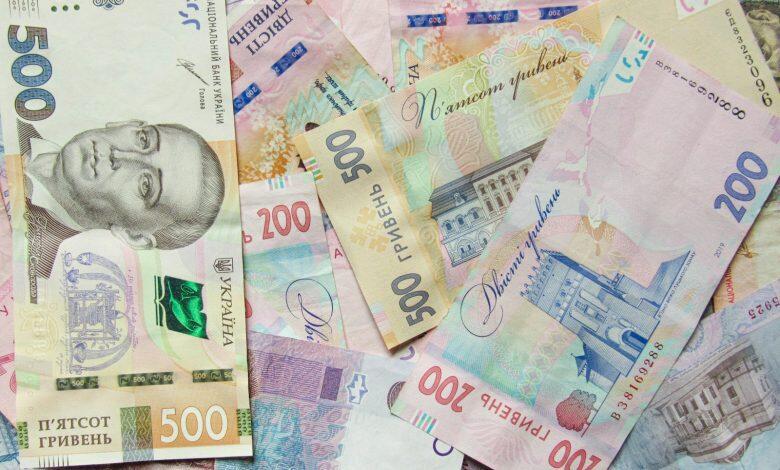 a pile of different bank notes laying on top of each other